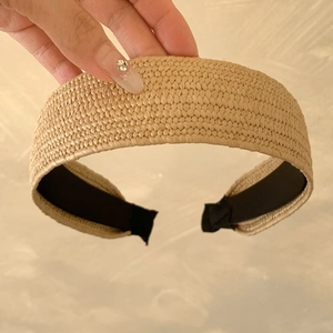Bohemian woven straw headband for women featuring natural fibers and wide summer vacation style