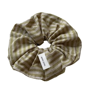 Minimalist green and beige striped fabric scrunchie with handmade woven label