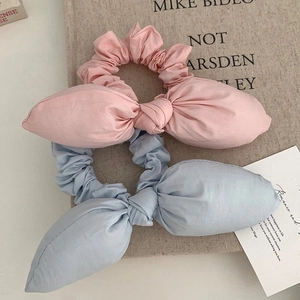 Pink and light blue bunny ear scrunchies set with a textured cotton fabric finish