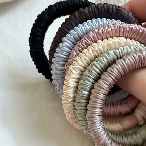 Set of 7 colorful pleated satin scrunchies with silky texture and elegant glossy finish