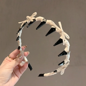 Ballet style non-slip headband with black teeth, white ribbon wrap and crystal bow