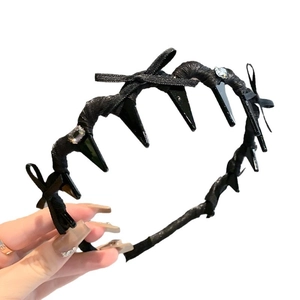 Ballet style black headband with bow, shark teeth spikes, and rhinestones for high top hair