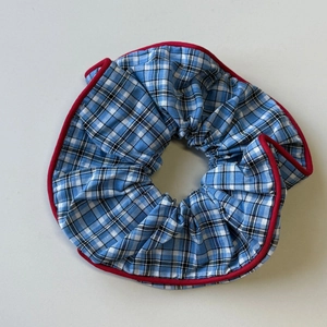 Plaid scrunchie with blue and white check pattern and contrast red piping edge