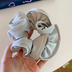 Detailed close-up showing high-density fabric texture of oversized light grey scrunchie