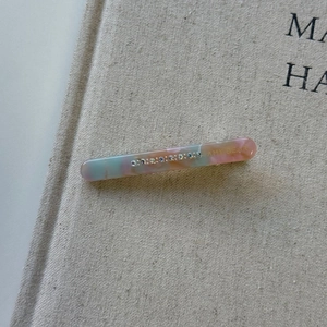 Detail of pink and blue marble acetate hair clip with multicolored rhinestones