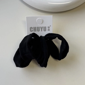Detailed close-up of a high-elastic black ice silk hair scrunchie with hanging card tag