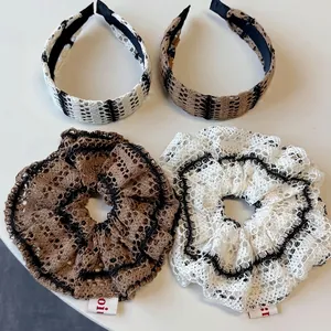 Lace knit hair accessories set featuring striped headbands and scrunchies in chic neutral tones
