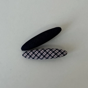 Close-up of navy plaid and black fabric BB hair clips for elegant styling accessories