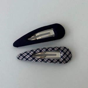 Detail of navy blue and plaid fabric-wrapped metal BB hair clips in a two-piece set