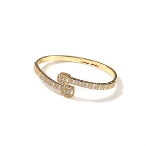 Luxurious bypass gold-plated bangle featuring shimmering pave-set cubic zirconia stones