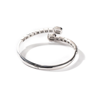 Macro shot of a silver bypass bangle with rectangle ends and micro pave zircon stones