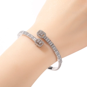 Silver staggered bangle with square diamond accents shown on woman's wrist