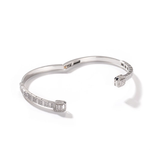 Macro shot of silver plated hinged bracelet with pave zirconia and geometric patterns