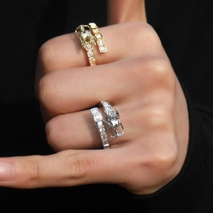 Detailed view of 3D dragon ring with cubic zirconia inlay on human hand in gold and silver