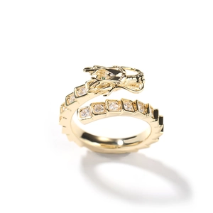 Macro detail of golden dragon ring with sparkling square-cut cubic zirconia stones