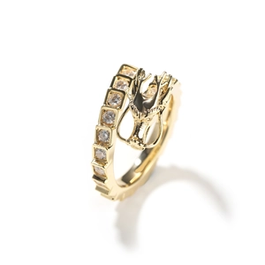 Detailed macro view of the golden 3D dragon head design with sparkling zircon stones