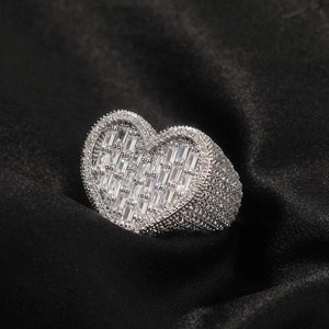 Macro detail of luxury heart ring with baguette-cut zircons on black satin