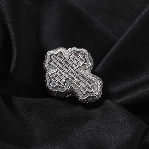 Detail of silver cross ring with baguette cut stones and pavé set cubic zirconia