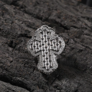 Macro shot of silver hip hop ring with cross design and pave set cubic zirconia stones