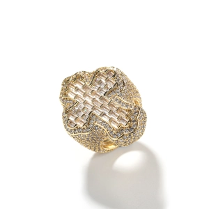 Macro shot of gold hip-hop cross ring with iced out baguette and round zircons