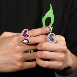 Close-up of heart-shaped hip hop rings with pink and purple pavé zircon stones
