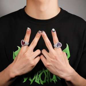 Detail showing oversized heart-shaped rings with red and purple emerald-cut zircons