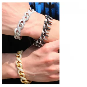 Macro view of iced-out Cuban link bracelets in gold and silver with zircon details