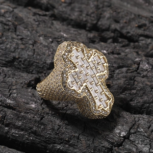 Macro shot of gold iced-out hip hop ring with baguette-cut cross and micro-pave stones