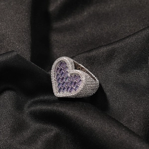 Macro view of iced out heart ring with purple rectangle crystals and pave white zircon