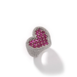 Detailed close-up of a large heart-shaped ring with pink baguette and pavé white zircons