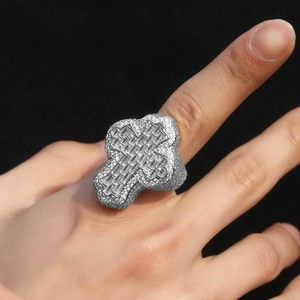 Detail of silver hip hop cross ring with micro-paved cubic zirconia on hand