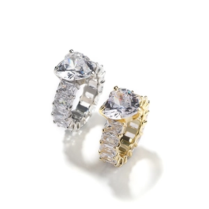 Detailed macro of gold and silver heart-shaped eternity rings with baguette-cut zircons