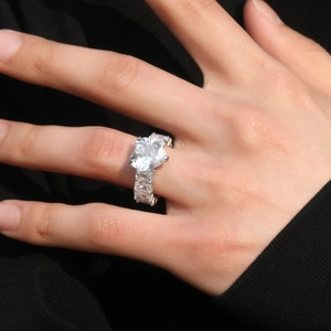 Elegant heart-shaped silver ring with emerald cut cubic zirconia stones in pave setting