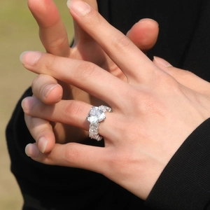 Macro shot of silver heart cut ring with rectangular zircon pave on the band