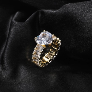 Close-up of heart-shaped zircon gold eternity ring on elegant black satin background