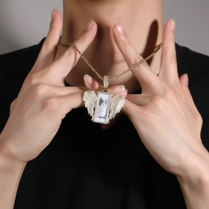 Detail of hip hop wings photo pendant necklace with gold chain and clear crystals