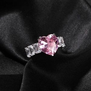 Elegant silver heart ring with pink zircon and baguette side stones on black silk