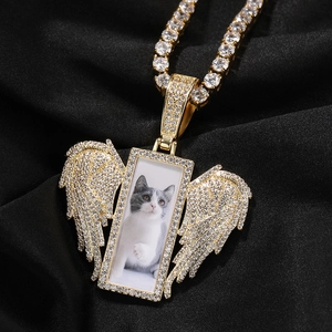 Macro shot of hip hop gold angel wing photo pendant with sparkling micro-inlaid stones