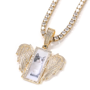 Macro view of iced out angel wings rectangular photo locket with sparkling zircons