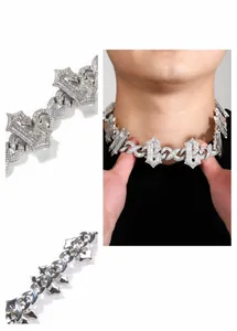 Detail of silver iced out hip hop necklace with crown pendant and cubic zirconia stones