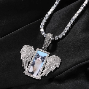 Macro shot of silver hip-hop wing pendant with custom cat photo and tennis chain