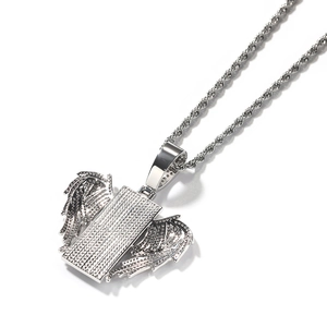 Macro detail of silver hip hop iced-out rectangle pendant with wings and rope chain