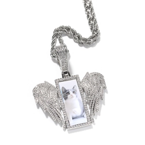 Detail view of silver hip hop wing pendant with custom photo and cubic zirconia stones