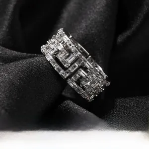 Detailed close-up of a hip hop ring with Greek key pattern and cubic zirconia stones