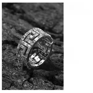 Macro shot of silver hip-hop ring with Greek Key cutout and baguette-cut cubic zirconia