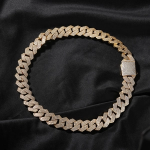 Close-up of 19mm gold plated Cuban link chain with square clasp on black silk