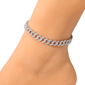 Close-up of silver Cuban link anklet with full cubic zirconia stones on foot