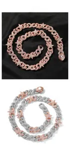 Detail view of iced out Cuban link necklace with star accents in rose gold and silver