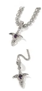 Detail of hip-hop sword pendant with purple stone and sparkling zirconia on dual chains
