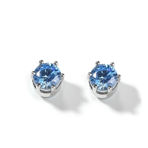 Macro detail of 8mm round blue zircon earrings with a classic six-prong silver setting